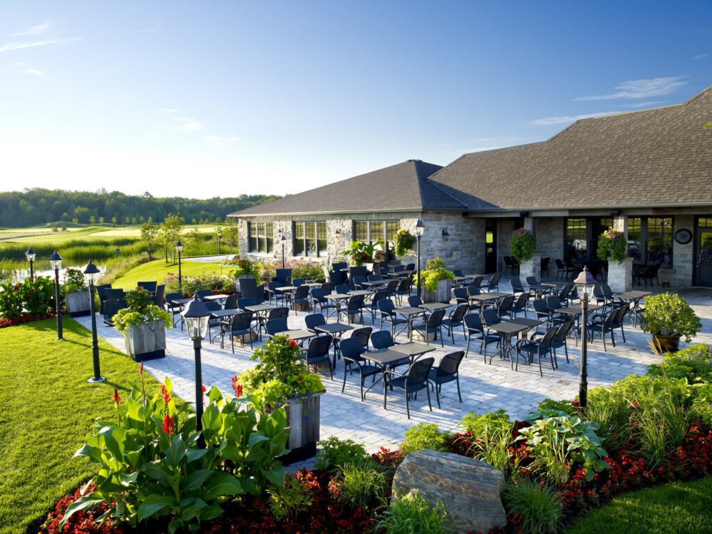 Image of Piper's Heath Patio in the summer with blue sky and tables perfectly aligned