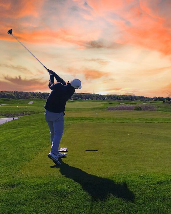 Golfer teeing off on hole 14 at Piper's Heath